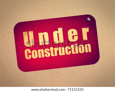Red billboard with under construction text over wooden background