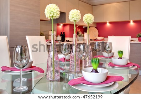 glamorous table setting ready for dinner party with kitchen background