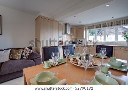 Modern stylish dining kitchen dressed in a fashionable manner with table set for dinner