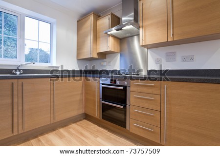Modern fitted kitchen units within new home including built-in appliances