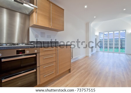 Modern Kitchen family room in brand new property with fitted appliances and window overlooking garden