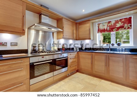 Luxury modern fitted kitchen with stainless steel appliances, granite work surfaces and two ovens