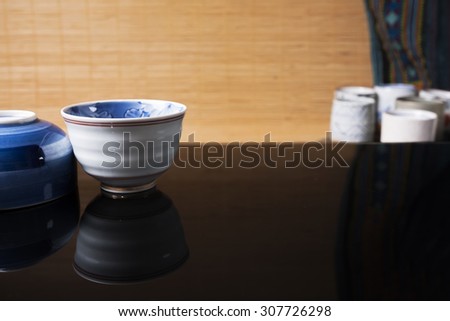 Reflection of traditional Japanese ceramic product on black glass