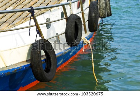 Nautical background with a ship. Tourist motorboat with mooring ropes at sea background. Aboard a boat moored in the port.
