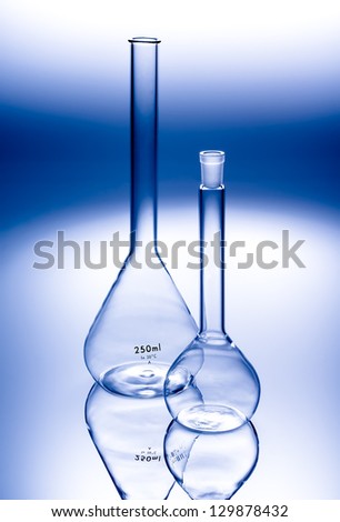 Glass flasks in a chemical laboratory. Scientific equipment for mixing liquids and conducting science experiments and research.