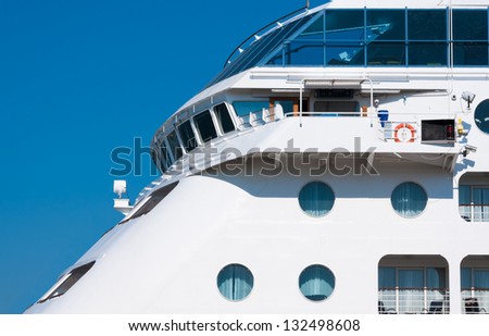 View from the upper deck of a cruise ship. Captain\'s bridge on the luxury ocean liner. Seaside of the white passenger ship with portholes.
