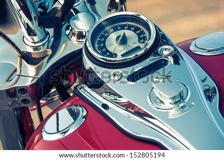 Motorcycle detail with gasoline tank and speedometer. Chrome motorcycle details closeup.