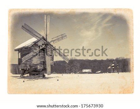 Retro image of the old windmill on paper texture. Vintage background with a wooden wind mill of the grunge style.