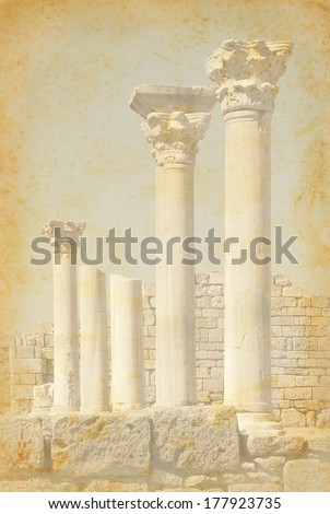 Ancient architecture with marble columns. Retro image of the antique building on paper texture. Vintage background with classic columns of the grunge style.