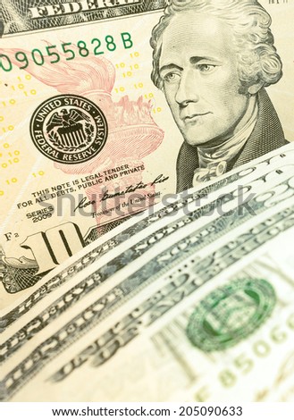 Ten Dollar Bills closeup with soft focus. Closeup of Andrew Hamilton\'s portrait on a US 10 dollar banknote. American president Hamilton on the ten dollar bill.