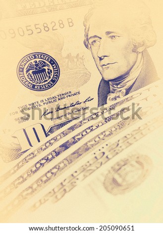 Ten Dollar Bills closeup with soft focus - design elements on vintage style. Closeup of Andrew Hamilton\'s portrait on a US 10 dollar banknote. American president Hamilton on the ten dollar bill.