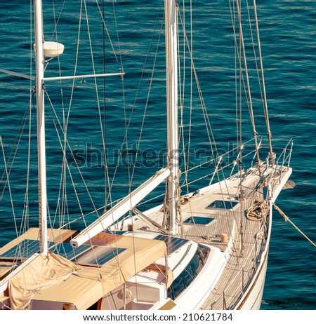 Exterior of cruising yacht - deck, portholes and mast. Yachting tourism - romantic trip on classic yacht. Nautical equipping and marine tools on sailboat - tackles on the yacht.