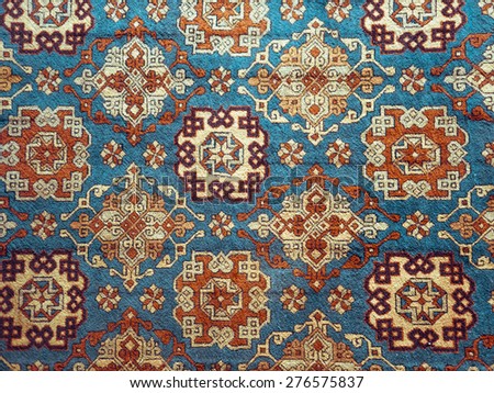 Persian carpet - texture background with oriental ornament. Traditional wool rug - oriental craft, decor of home interior.