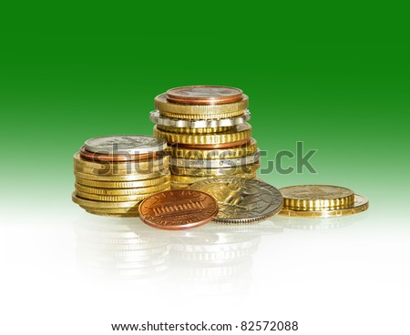 Stack of coins isolated on white and green background. American coins pile with euro coins and some of the wold money for banking operations.