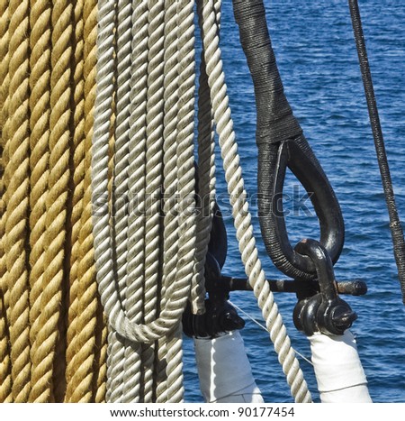 Marine ropes, rigs and mast tackle at the old nautical vessel. Tackles of ancient sailboat. Ship ropes with rigging and pulley.