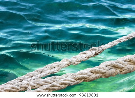 Marine ropes for mooring yachts against the sea background. Anchor rope in the harbor.