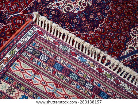 Handmade woven rug and tapestry - vintage carpets on a Turkish bazaar. Traditional Turkey rugs - oriental craft and decor of interior.
