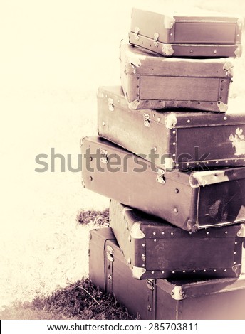 Old suitcases at outdoor, lifestyle in retro style. Travel concept with vintage bags, monochromatic colors and soft focus. Trip of the road with a baggage. Copy-space for your text, vertical view.
