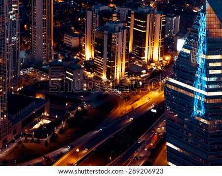 Panorama of Istanbul aerial view at night with office building and skyscrapers. Nightlife in Istanbul, evening illumination, top view of the city. Modern townscape with night streets.