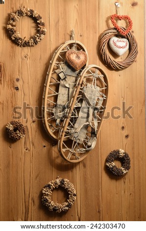 Old Snow Rackets on Wood Wall with Wreaths and Garlands in a Mountain Cabin