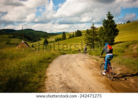 Landscape. Carpathian Mountains in early summer, tourists on bikes and ride on the tourist route. Ukraine. Pylypets.