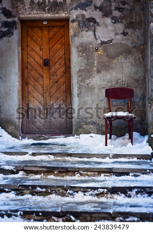 City landscape, objects. Old door and chair. Stairs in the snow.