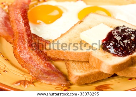 Bacon and eggs along with toast and jelly for the perfect not so healthy breakfast