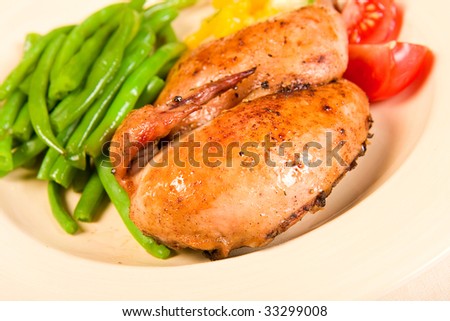 Half a Cornish hen served with green beans and mango salsa