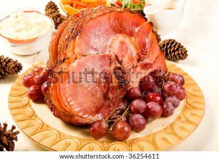 Glazed Spiral Sliced Ham garnished with red globe grapes