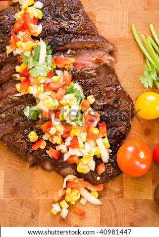 Whole flank steak served with corn salsa