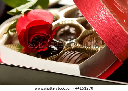 Valentine's day roses and candies on black tray