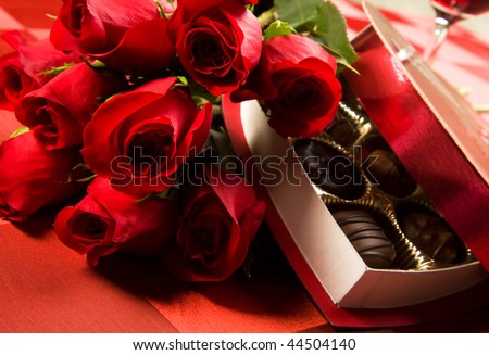 Valentine\'s day roses, candies and wine on black tray