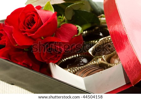 Valentine's day roses, candies and wine on black tray