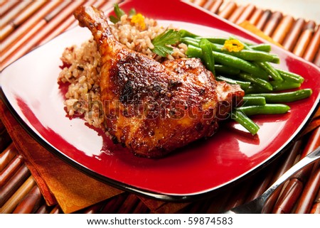 Duck with tamarind sauce accompanied by wild rice and green beans