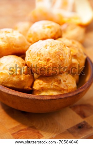 Freshly made cheese gougere on wood cutting board