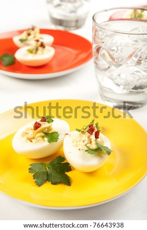 Holiday and party favorite deviled eggs on colorful plates