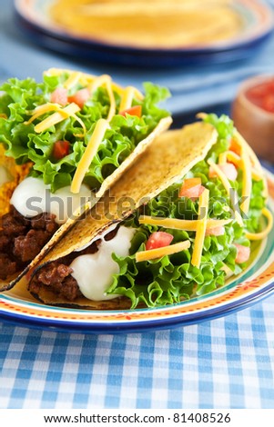 Deluxe hard shelled beef tacos served with salsa