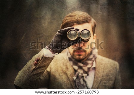 Vintage fashion man looking trough binoculars. paper texture
