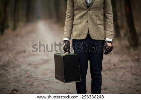 Vintage Smart casual outfit man with suitcase