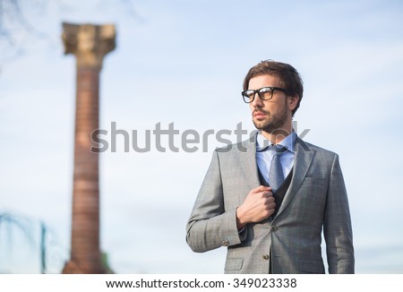 Fashion model man posing in autumn park. Smart casual outfit.