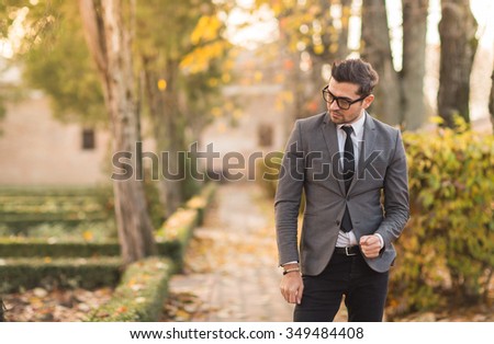 Smart casual outfit model in autumn park.