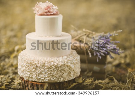white wedding cake. Shabby chic. decoration with vintage books and lavander