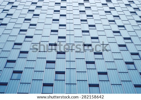 Abstract view to steel blue background of glass facade of a skyscrapers. Modern architecture.