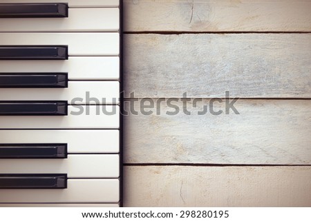 Inspirational background with a piano on a wooden table while composing. Top view and a copy space for editor\'s text.