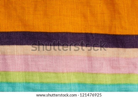 Stamped multicolored lines fabric. Natural linen fabric.Pink, blue, green and orange clors.