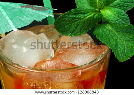 Ice tea with lemon.Closeup glass ice tea with ice cubes and mint.