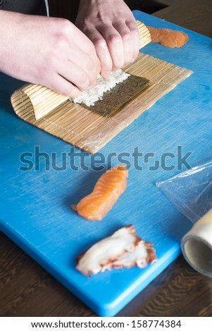 Sushi in sushi bar. Sushi making.Hands rolling sushi