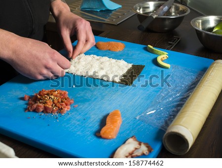 Sushi in sushi bar. Sushi making.Hands rolling sushi