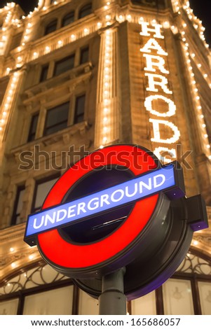 London, United Kingdom - Circa November 2013:Harrods Department Store. Facade Illuminated At Night. Underground Sign.