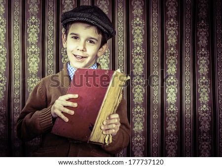 Child with red vintage book. Vintage clothes and hat